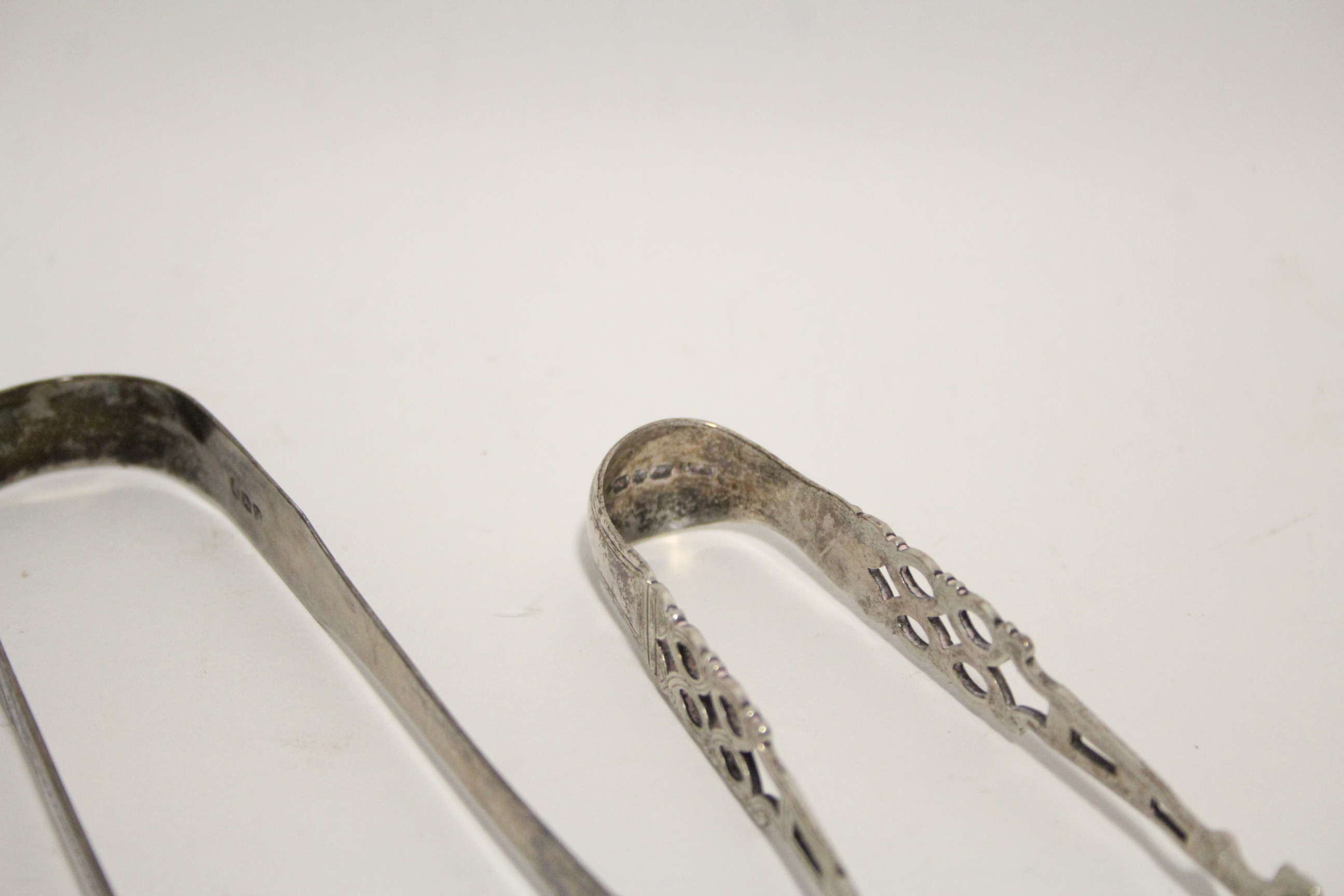 A pair of Victorian sugar tongs in the mid-18th century style, with pierced stems & shell bowls, - Image 2 of 2