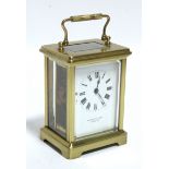 A brass carriage timepiece, the white enamel dial inscribed: "Pridham & Sons, Torquay"; 4½" high.