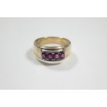 A 14K gent's ring set four oval rubies.