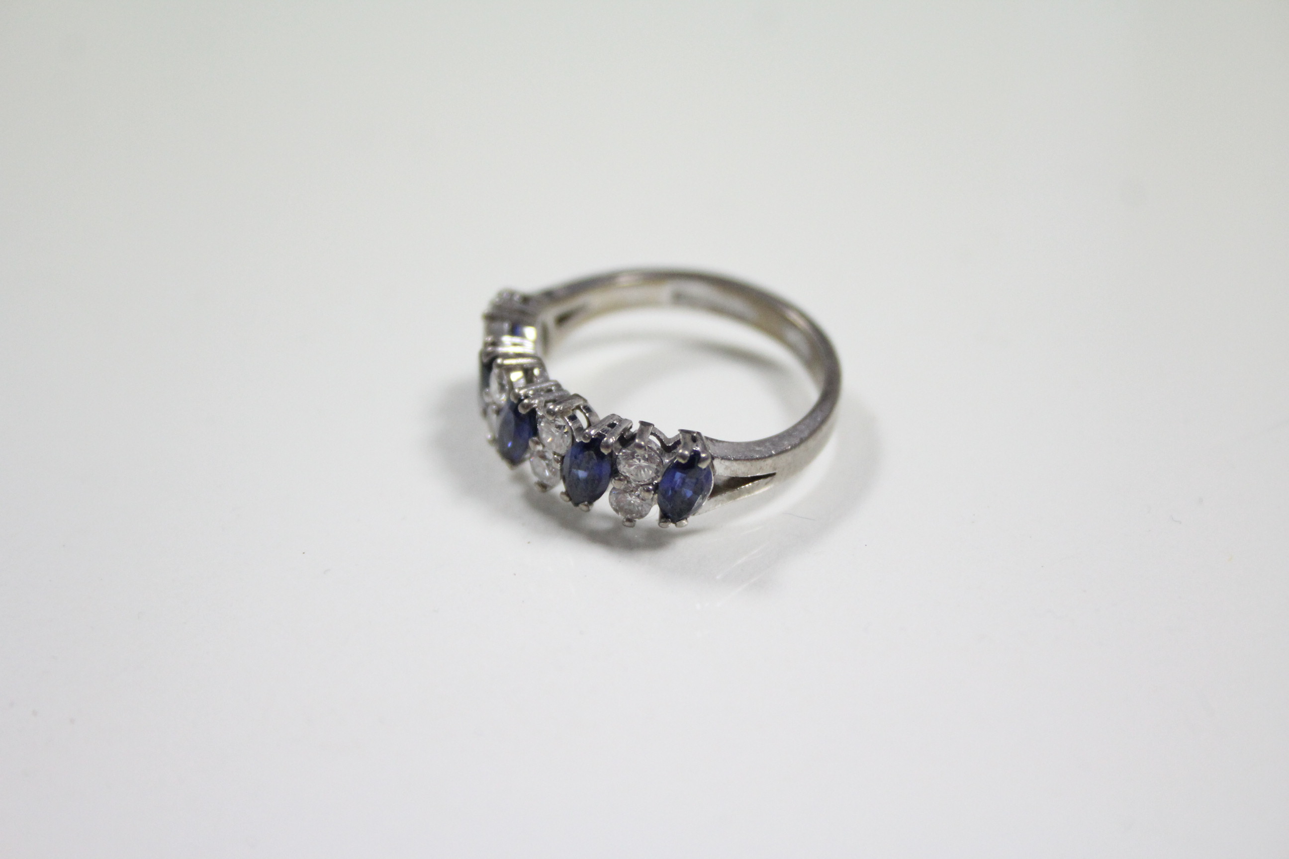 A SAPPHIRE & DIAMOND RING, the five navette-shaped sapphire set at a slight angle & divided by - Image 2 of 3