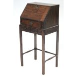 An 18th century style mahogany small bureau, the sloping fall-front enclosing fitted interior, one