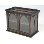 A 19th century oak wall display cabinet, enclosed pair of glazed panel doors with lancet arches &