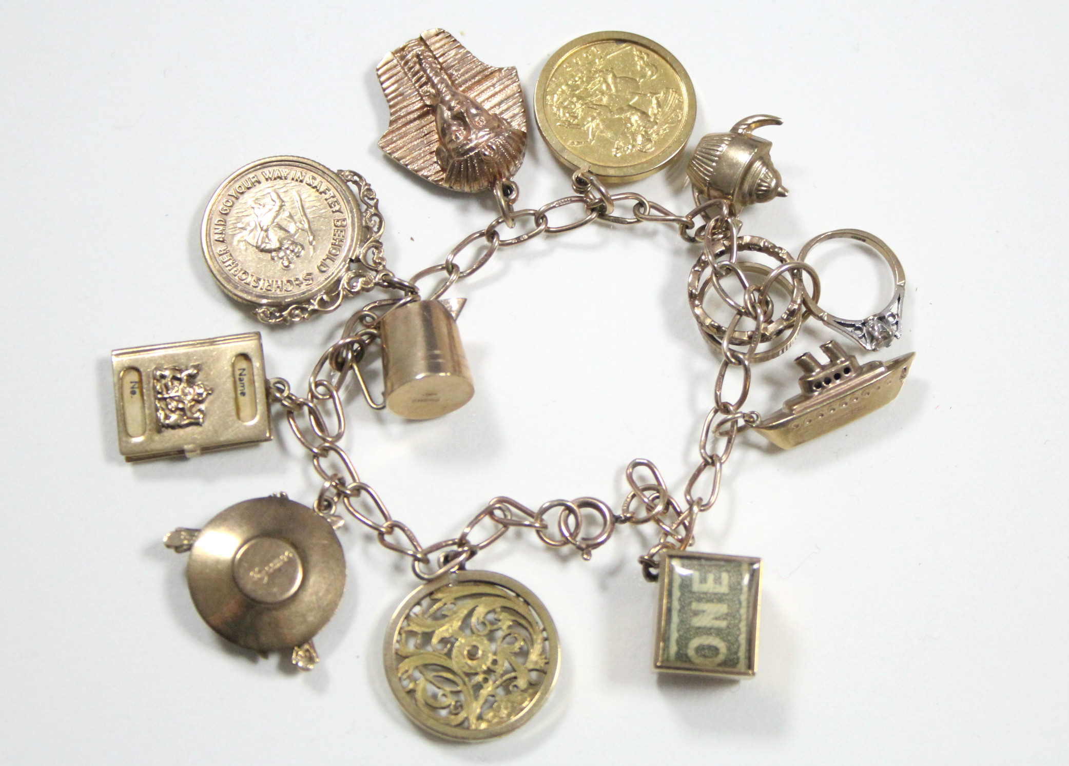 A 9ct. gold chain-link charm bracelet with pendant Edwardian half-sovereign (1901), eight various