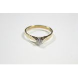 An 18ct. gold ring set single diamond; London hallmarks for 1982.