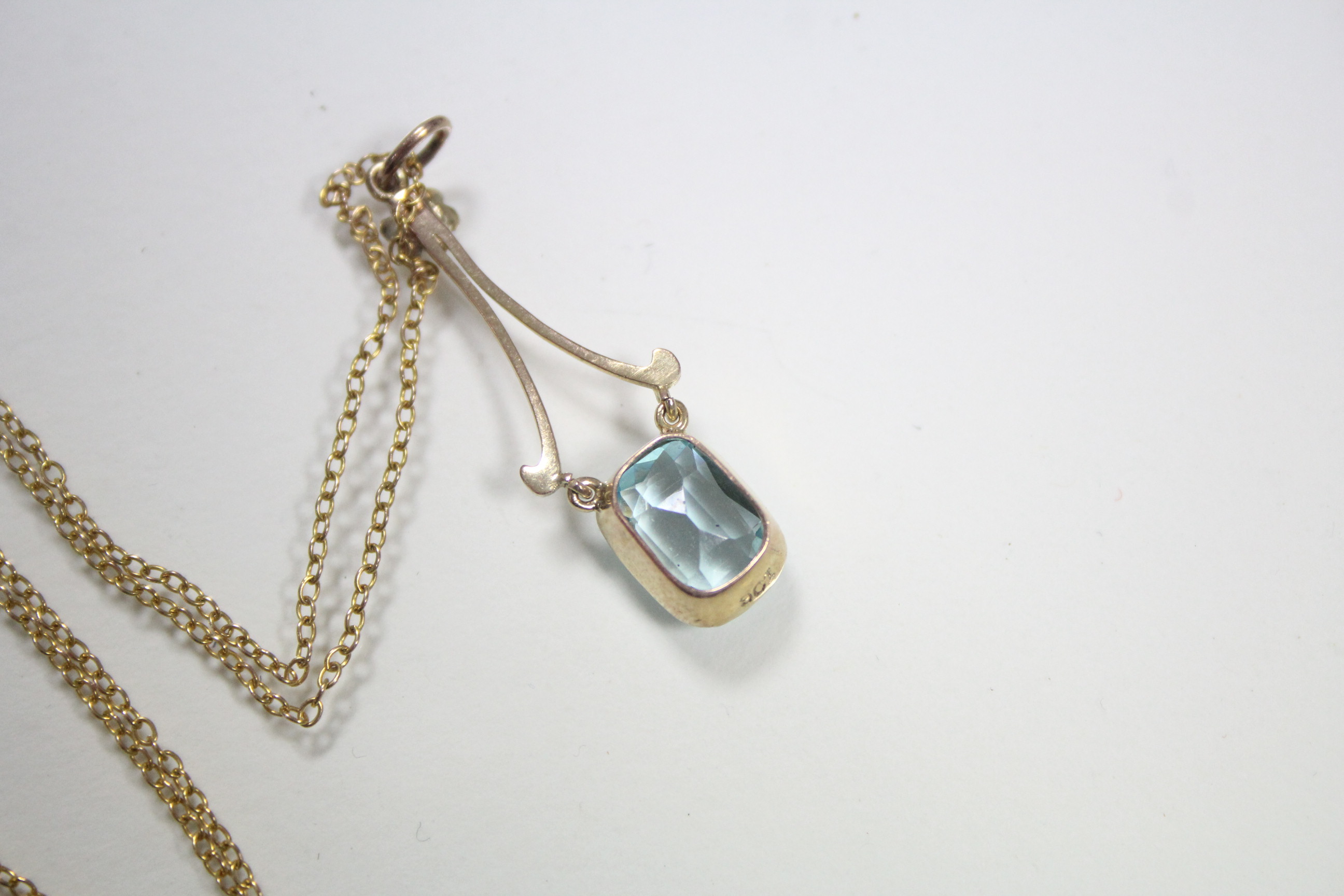 An aquamarine pendant, the articulated cushion-shaped stone set to 9ct. gold mounts, with seed pearl - Image 3 of 3