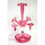 A LATE VICTORIAN CRANBERRY GLASS EPERGNE with central trumpet vase above three smaller trumpet