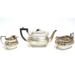 An Edwardian three-piece tea service in the regency style, of compressed oblong form, each with