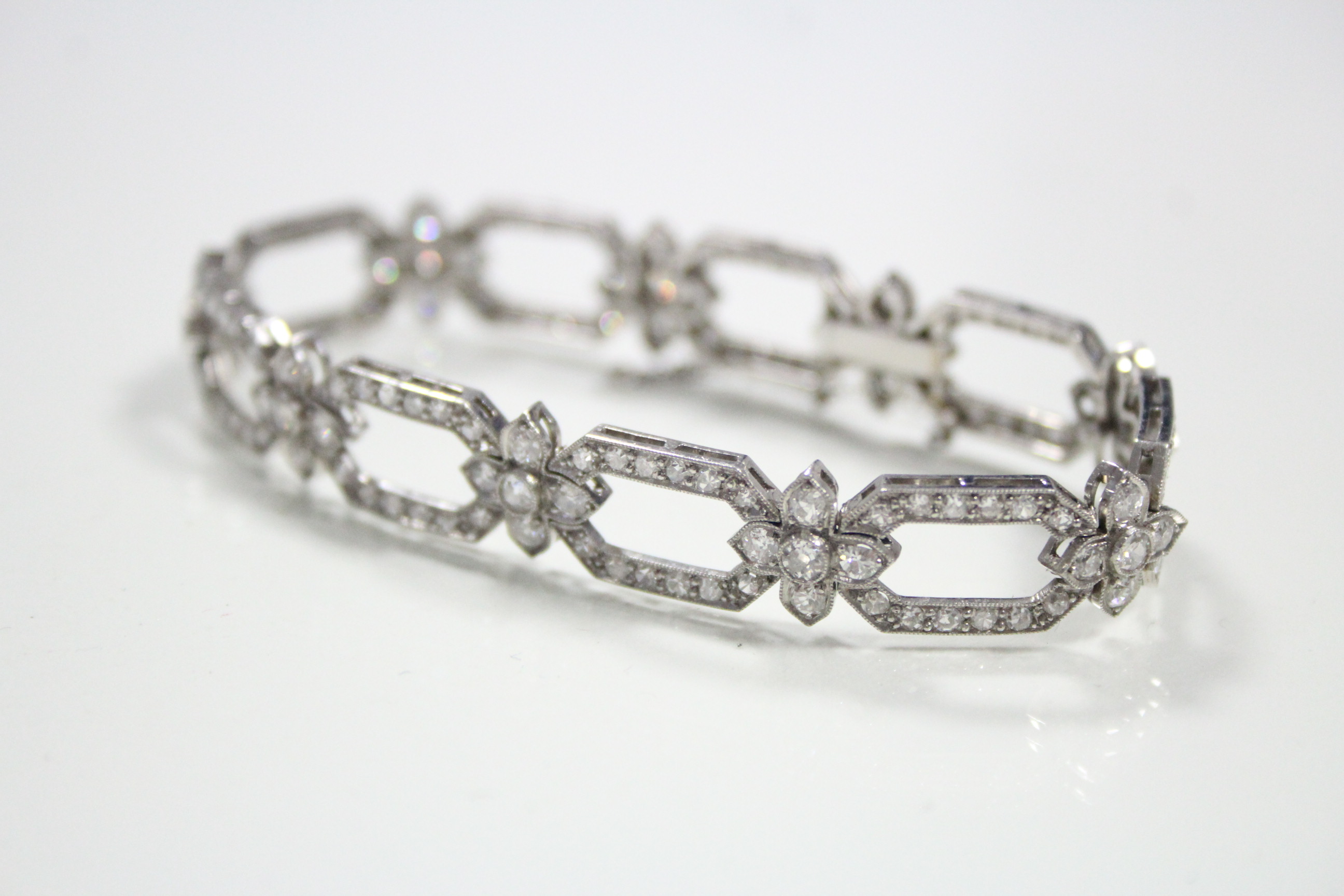 A DIAMOND BRACELET set one hundred & fifty three brilliant-cut & eight cut stones to nine