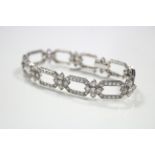 A DIAMOND BRACELET set one hundred & fifty three brilliant-cut & eight cut stones to nine