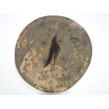 An eastern leather circular shield with four metal bosses & a hair-tuft to the centre; 26" diam.