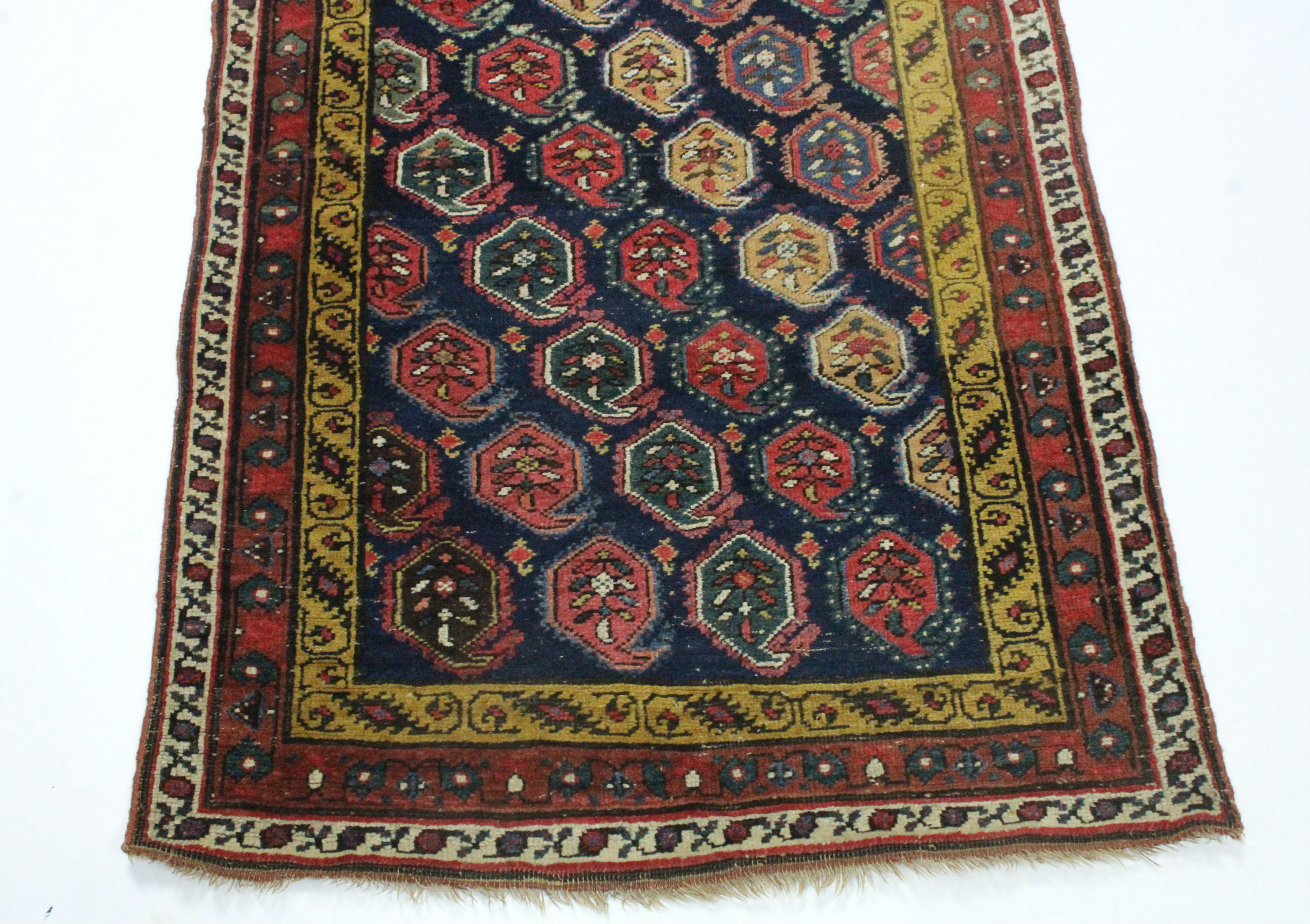 A PERSIAN RUNNER of dark blue ground, with repeating multi-coloured paisley design within mustard, - Image 2 of 3