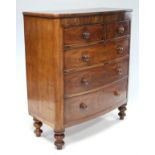 A Victorian figured mahogany bow-front chest fitted two short & three long graduated drawers with
