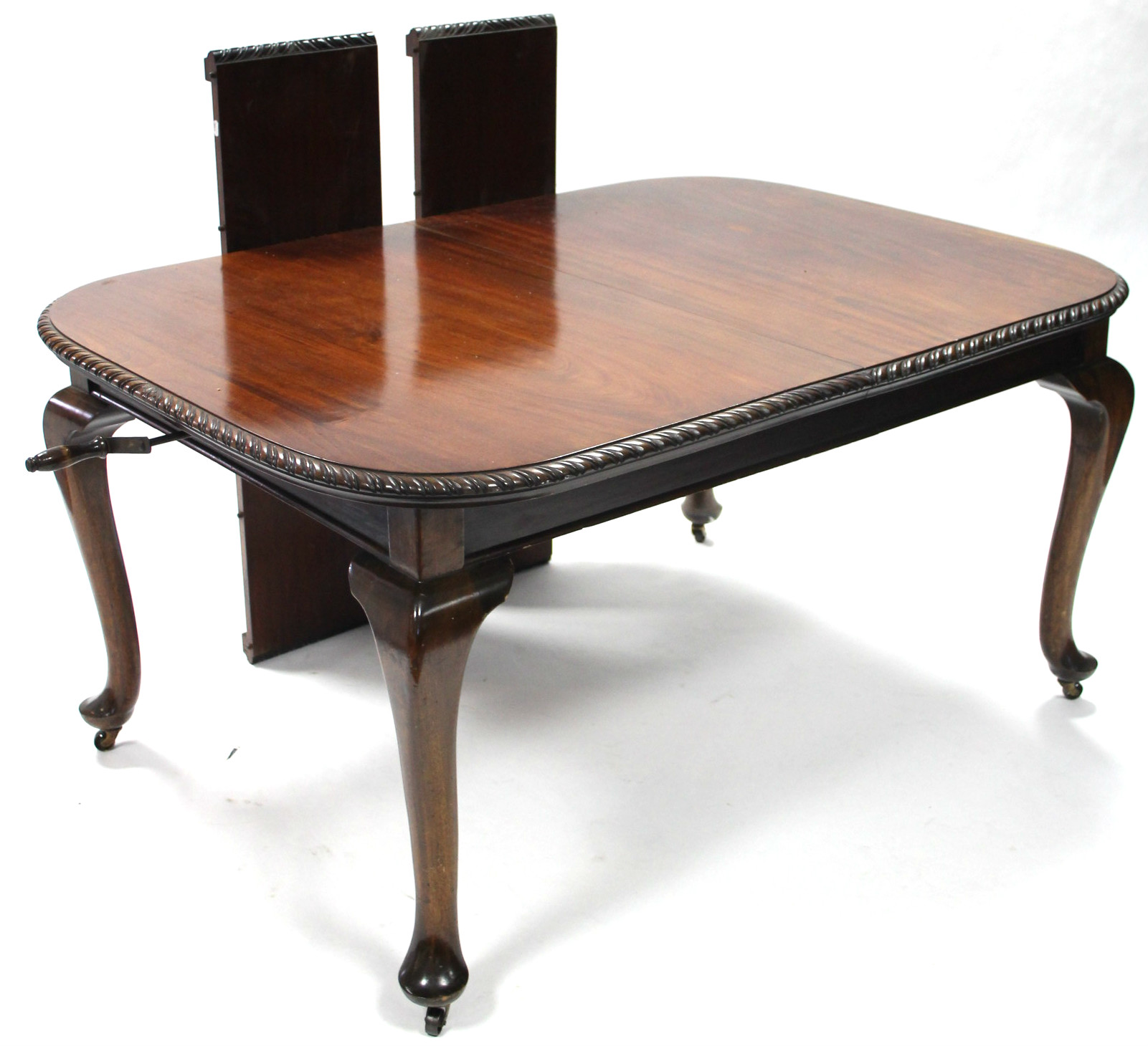 A late 19th/early 20th century mahogany extending dining table with wind-out action, the top with