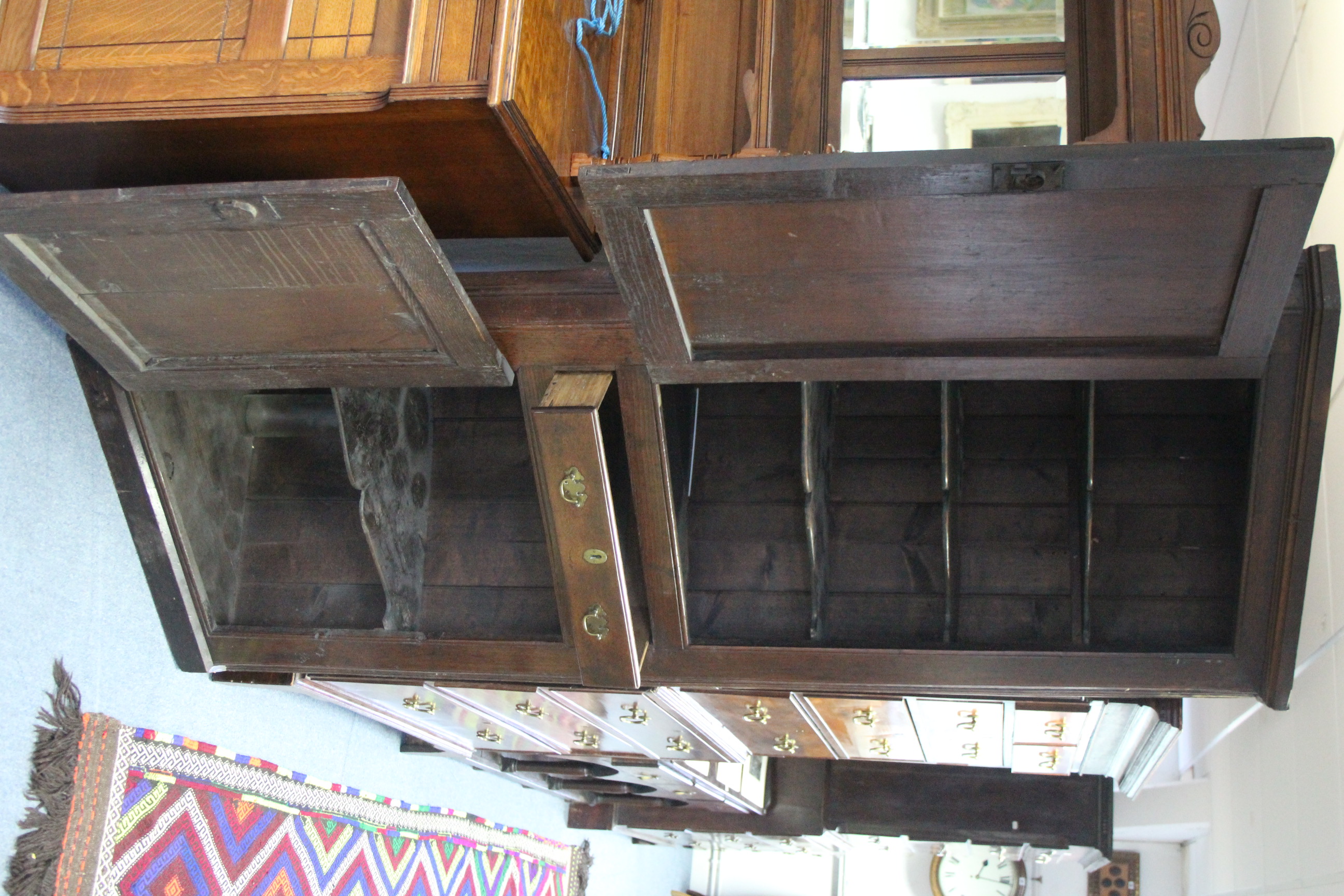 An 18th century oak standing corner cupboard with three shaped shelves to the top enclosed by - Image 2 of 2