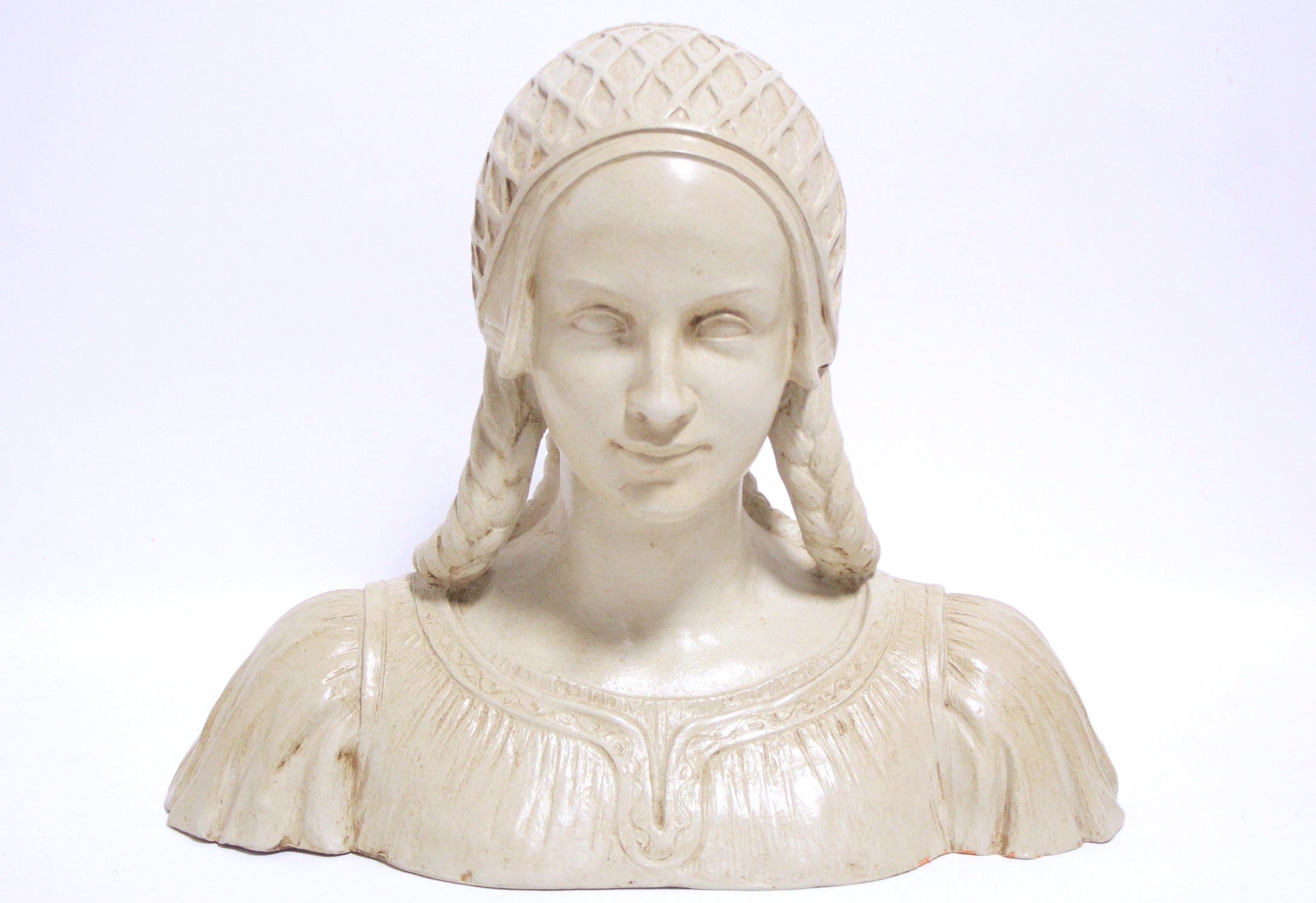 A painted terracotta bust in the renaissance style, of a young woman with plaited hair, signed to