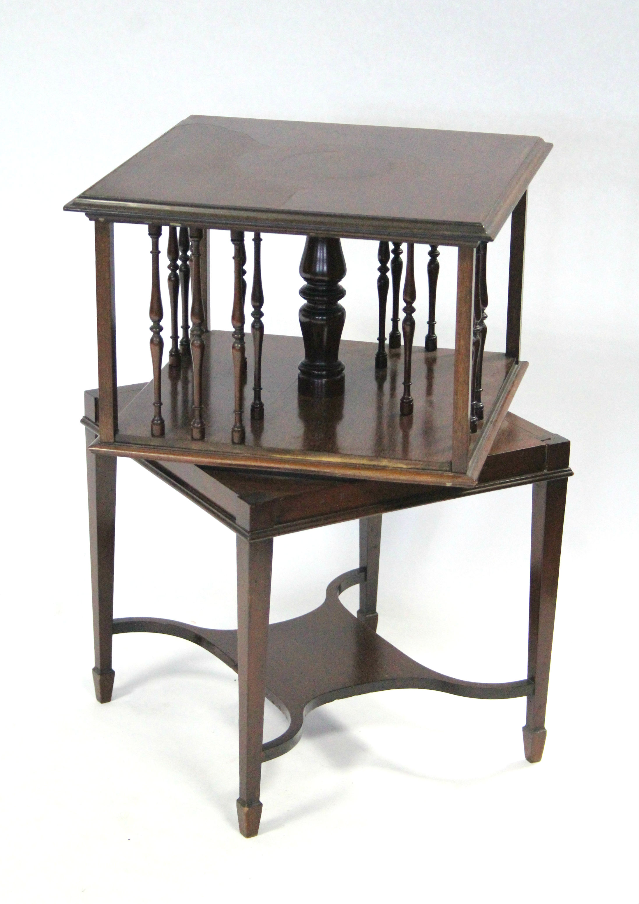 A 19th century mahogany small square revolving bookcase with central turned column, each side with