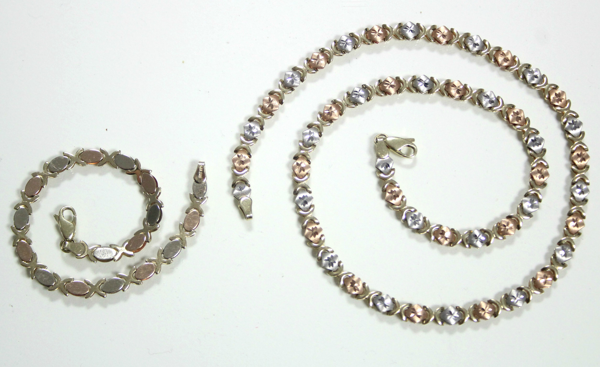 A 14K articulated necklace of alternating rose-pink & white engraved small oval panels, 17½" long ( - Image 2 of 2
