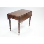 A Victorian mahogany Pembroke table with ring-turned & tapered legs on ceramic castors fitted end
