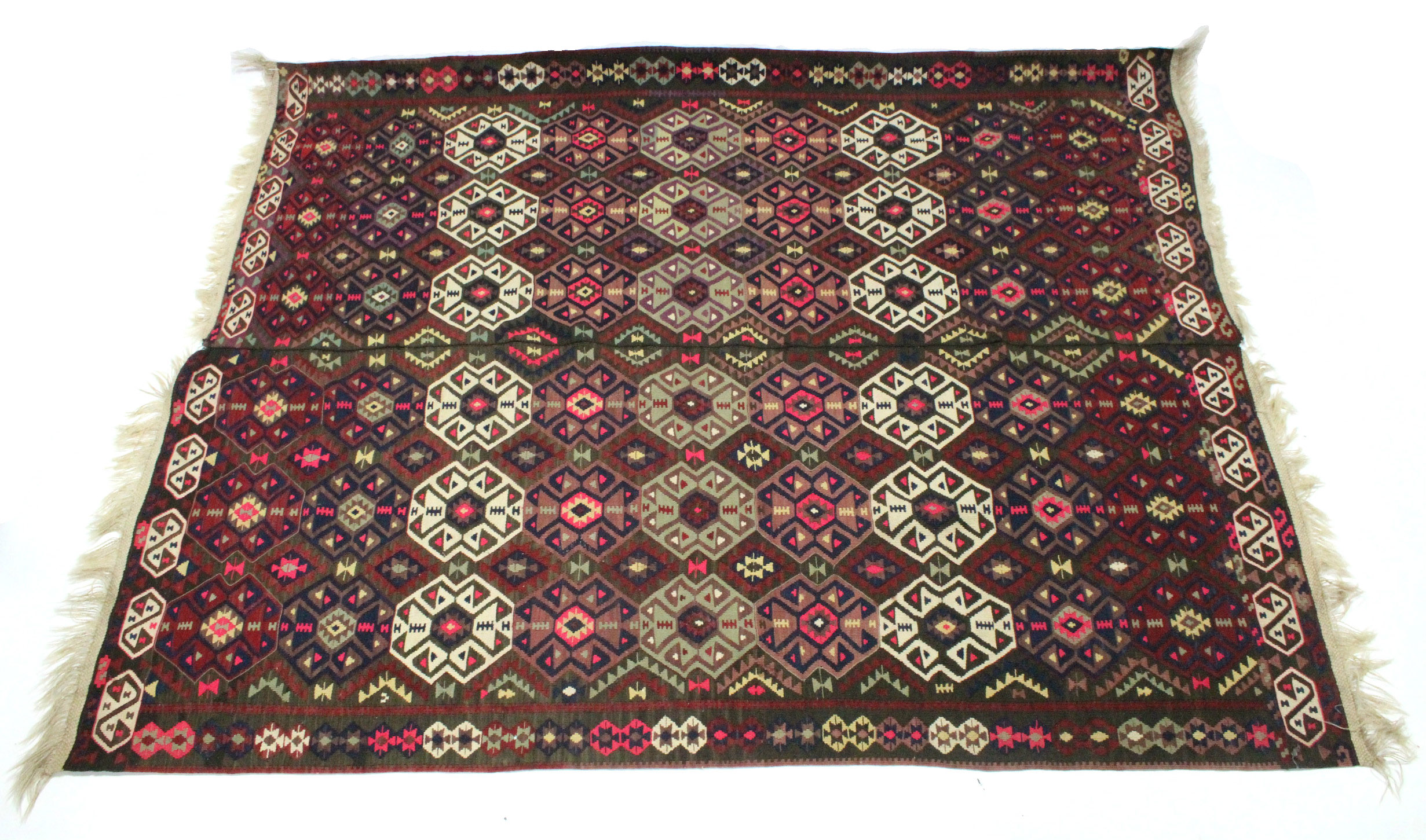 A Kelim rug with all-over brightly coloured geometric pattern & centre seam; 7’3” x 5’10”.