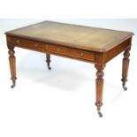 A VICTORIAN MAHOGANY WRITING DESK, the rectangular top inset gilt-tooled tan leather, fitted two