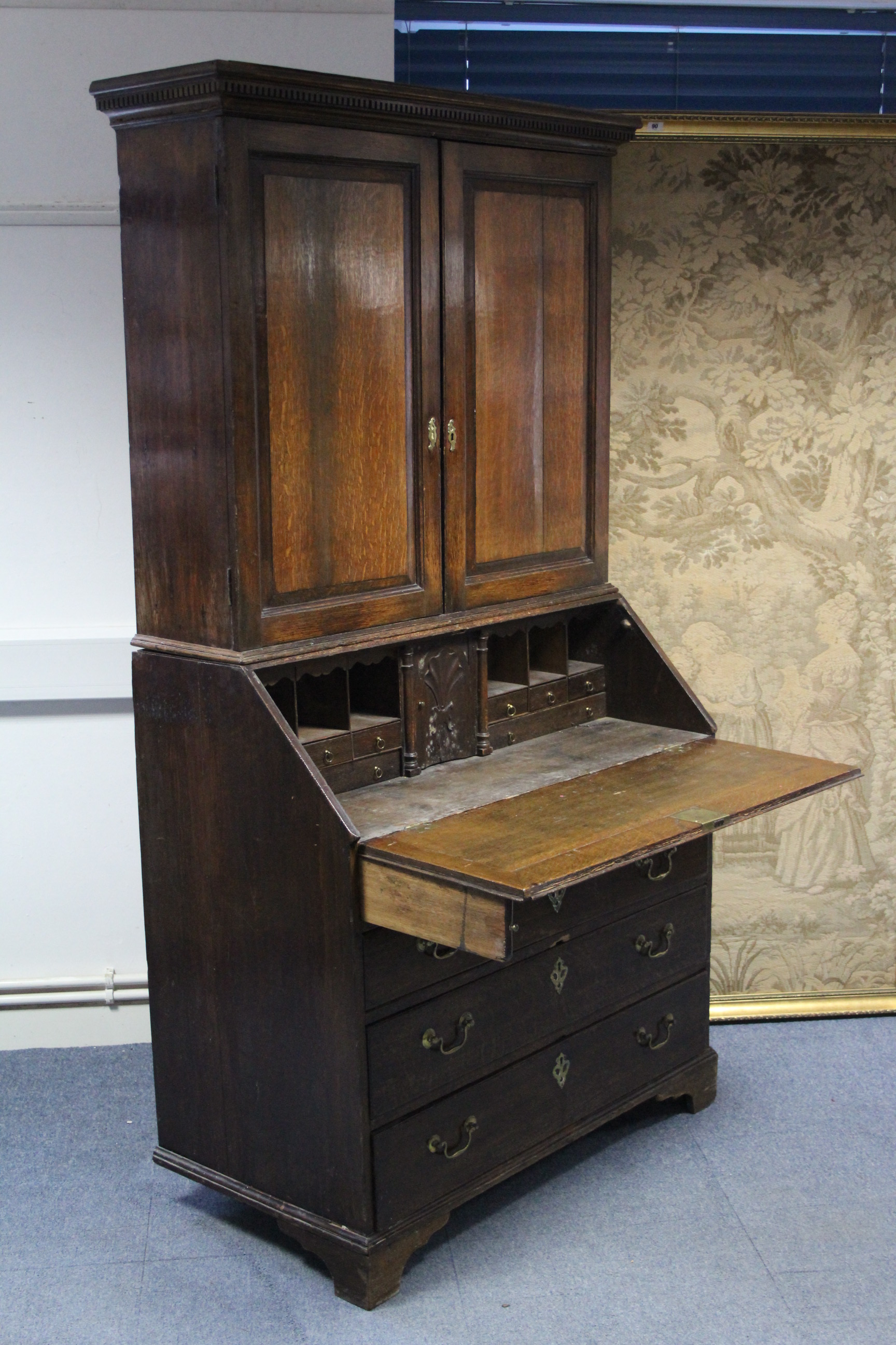 A late 18th century oak bureau-bookcase with adjustable shelves enclosed by a pair of panel doors, - Image 2 of 3