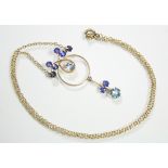 A 9ct. gold circular openwork pendant set aquamarine & sapphires, pendant drop below, on fine-link