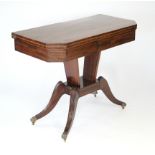 A REGENCY INLAID-MAHOGANY CARD TABLE, the rectangular fold-over top having canted corners with