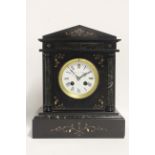 A Victorian striking mantel clock with 4" diam. white enamel dial, in black slate & green marble