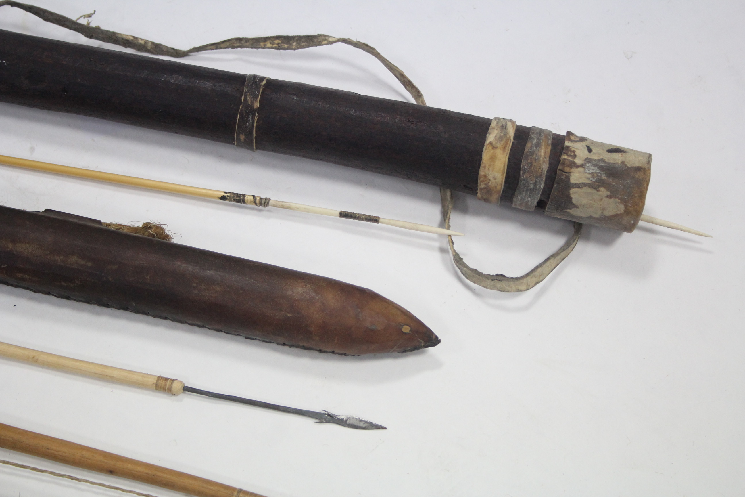 A collection of African artefacts including carved wood masks, spears, bows & arrows, fly-whisks, - Image 3 of 5