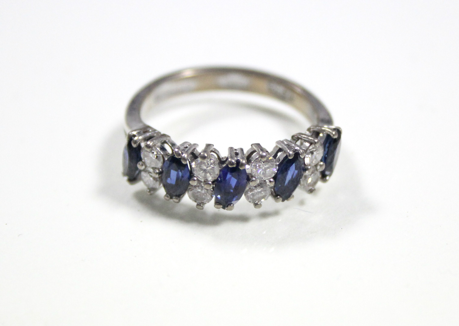 A SAPPHIRE & DIAMOND RING, the five navette-shaped sapphire set at a slight angle & divided by