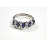 A SAPPHIRE & DIAMOND RING, the five navette-shaped sapphire set at a slight angle & divided by