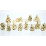 Twelve Japanese carved ivory miniature netsuke, each in the form of a seated immortal, & each
