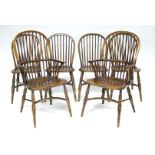 A set of six ash & elm Windsor spindle back dining chairs (including a pair of carvers), on turned