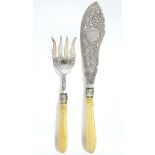 A pair of Victorian pierced & engraved fish servers with carved ivory handles; Sheffield 1869, by