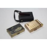 A rectangular powder compact with musical movement & Japanese gilt-brass & lacquer landscape