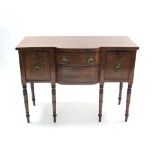 A regency mahogany small bow-front sideboard fitted central frieze drawer above an apron drawer, a