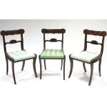 A set of three regency mahogany dining chairs with cared top & centre rails, padded drop-in seats