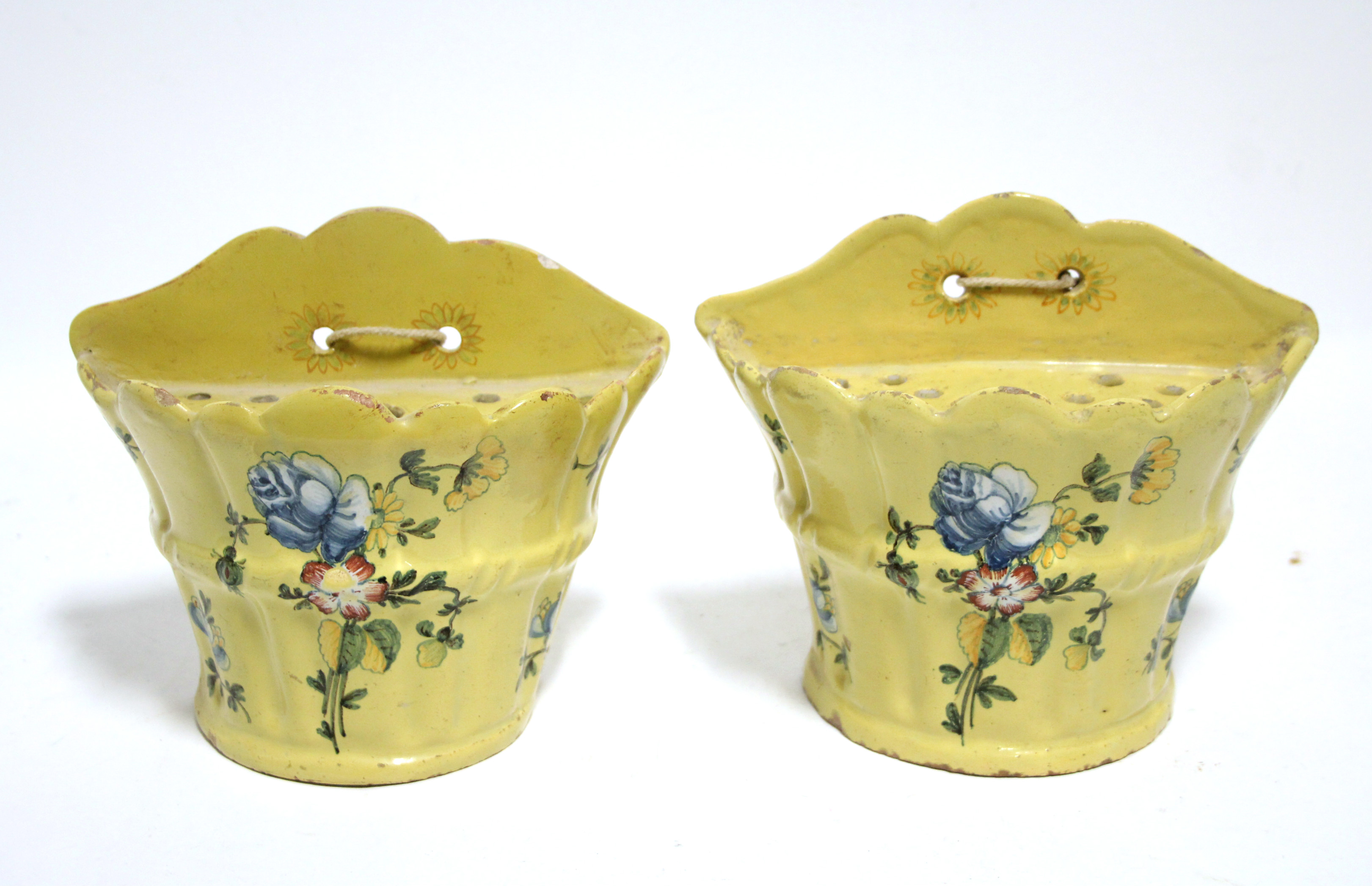 A pair of 18th century French yellow-ground faience bough bots of flared half-round form, each