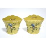 A pair of 18th century French yellow-ground faience bough bots of flared half-round form, each