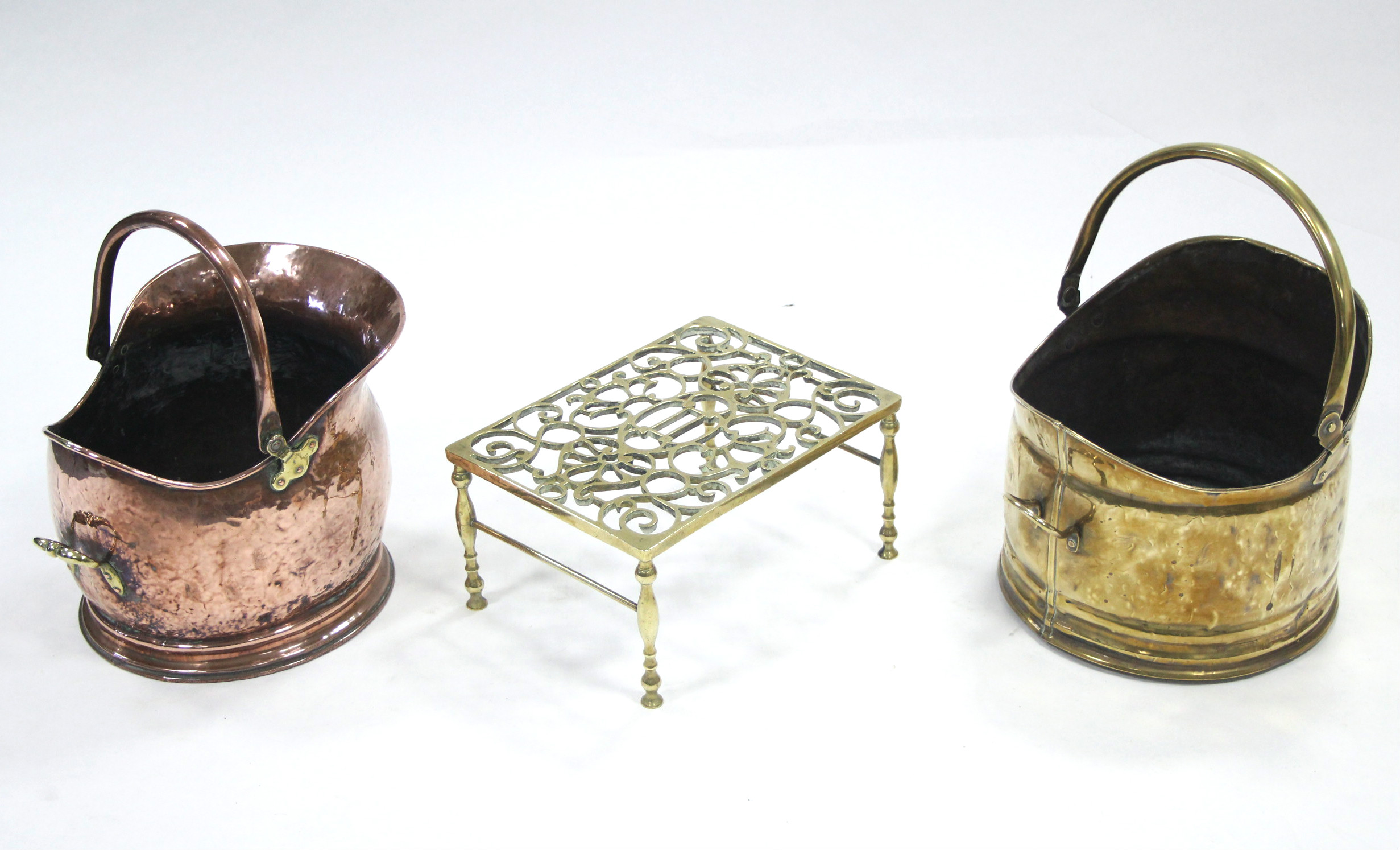 A pierced brass rectangular hob stand; a copper coal scuttle; & a brass ditto.