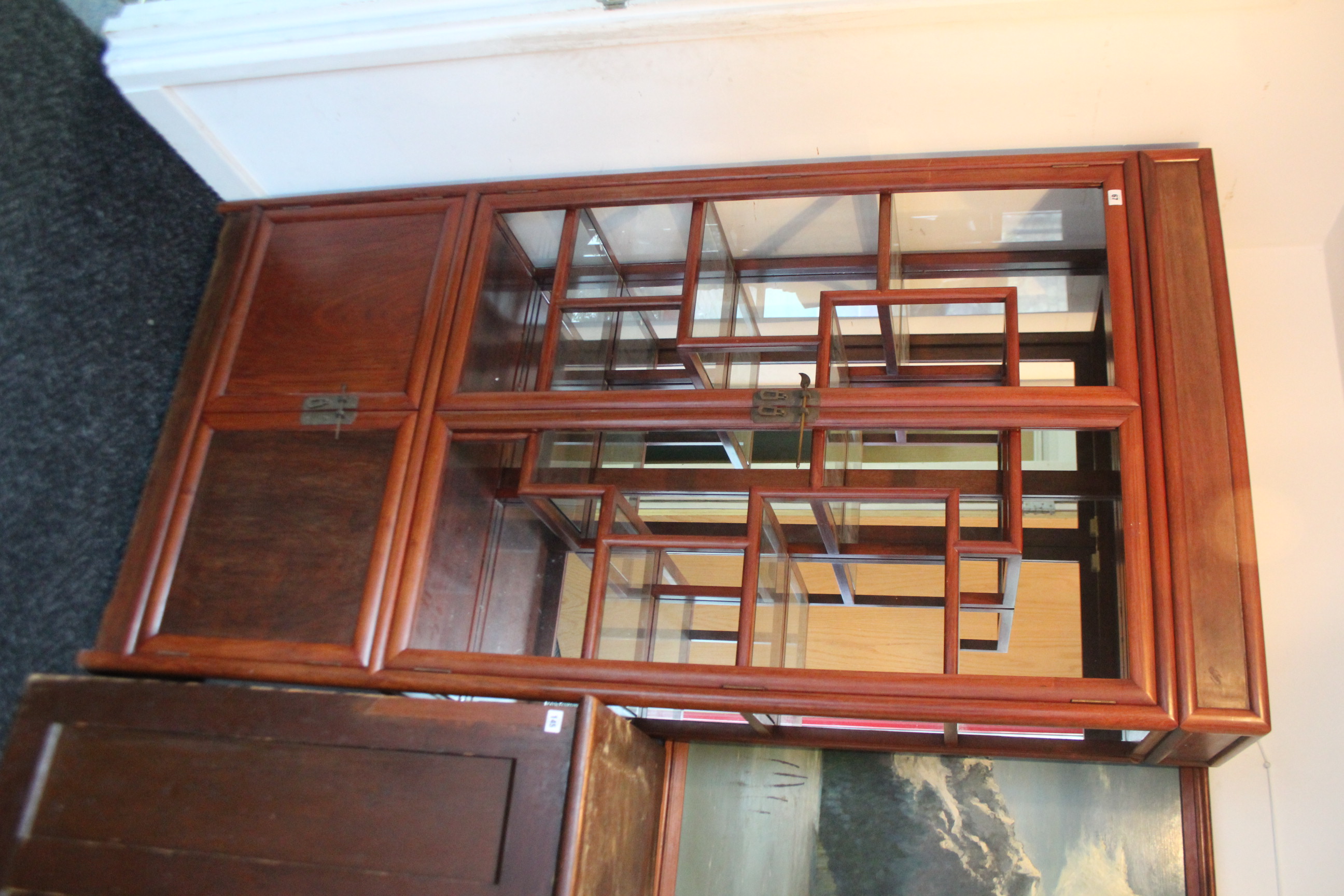 A Chinese hardwood tall china display cabinet (lacking glazed panels to doors & right-hand side),