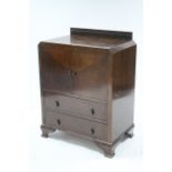 A small oak cupboard enclosed by pair of panel doors above two long drawers, & on bracket feet, 29¼”