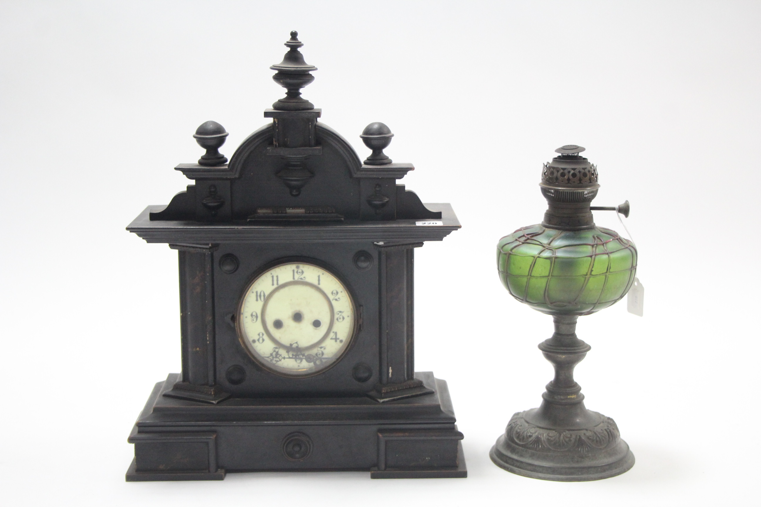 A Spelter oil table lamp with green glass reservoir having raised geometric design; & an early