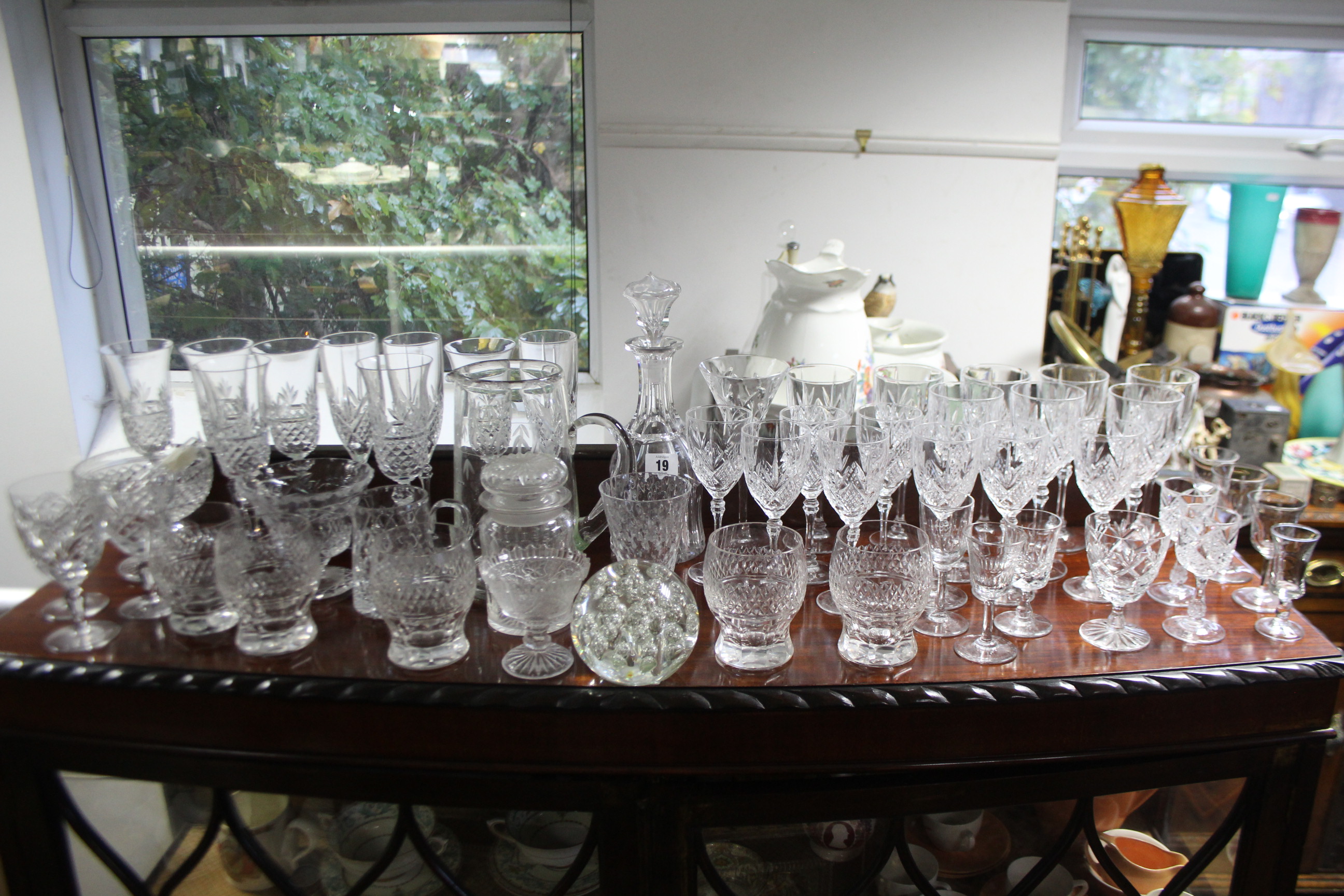 A heavy cut-glass mallet-shaped decanter; a glass paperweight, & various other items of glassware.