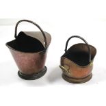 Two copper helmet-shaped coal scuttles, 12” & 9” high.