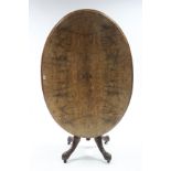 A 19th century inlaid-walnut loo table with oval tilt-top, & on turned supports & carved cabriole