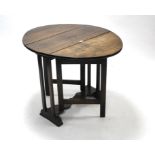 An early 20th century oak oval gate-leg occasional table on square legs with shaped centre