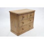 A Pine small chest fitted two short & two long graduated drawers with turned knob handles, & on