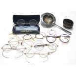 Ten various pairs of vintage spectacles; a silver plated napkin ring; & a silver plated tea