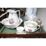 A Pountney & Co. floral decorated five-piece toilet set; a “Schweppes” glass soda syphon bottle;